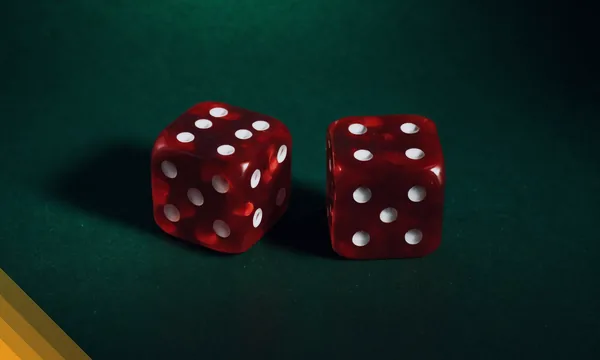 Two red dice resting on green felt for the 7 Up 7 Down call