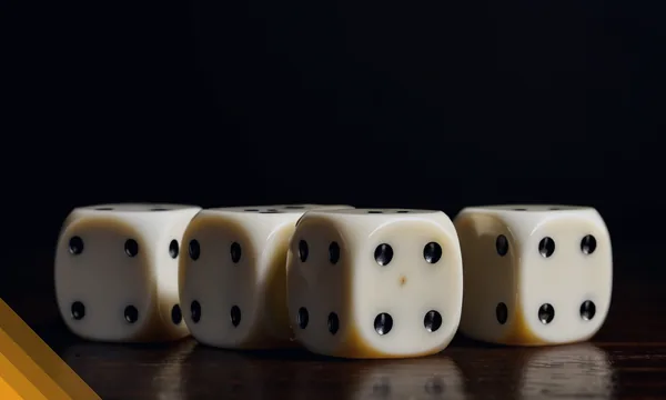 Row of white dice under a spotlight for the Kingmaker table games